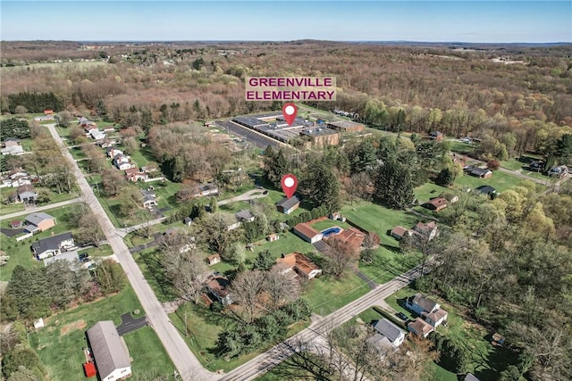 birds eye view of property with a wooded view