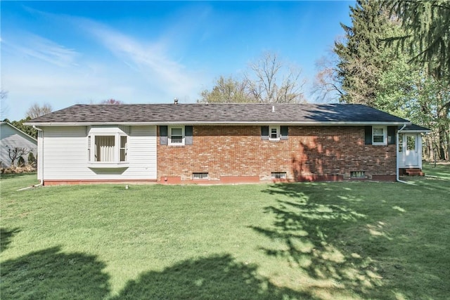 rear view of property with a yard and brick siding