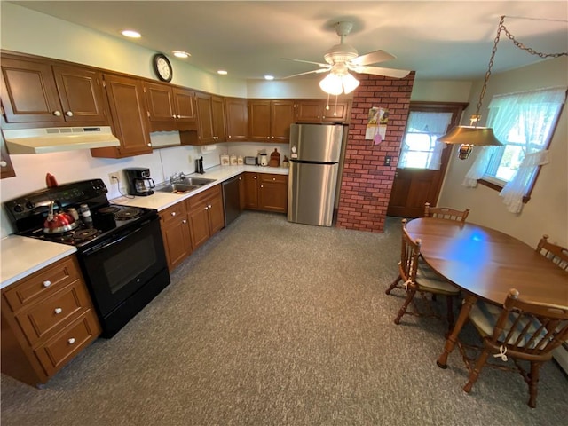 kitchen with a sink, under cabinet range hood, ceiling fan, light countertops, and appliances with stainless steel finishes