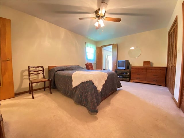 bedroom with carpet, a ceiling fan, and baseboards