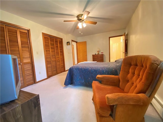 bedroom featuring a ceiling fan, carpet flooring, and multiple closets