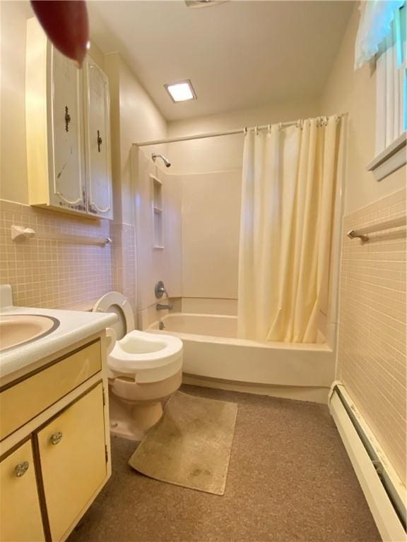 bathroom featuring vanity, tile walls, baseboard heating, and shower / tub combo with curtain