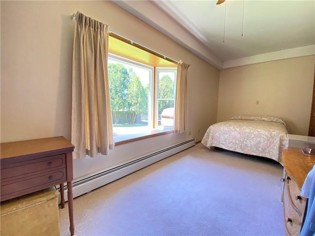 carpeted bedroom with a baseboard radiator and a ceiling fan