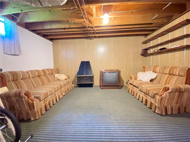 basement featuring wood walls and carpet floors
