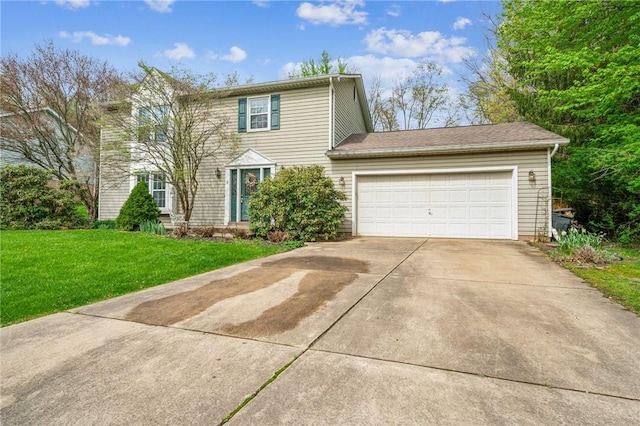 colonial inspired home with a front lawn, driveway, and an attached garage