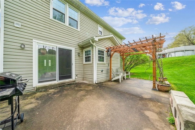 rear view of property featuring a patio area, a yard, and a pergola