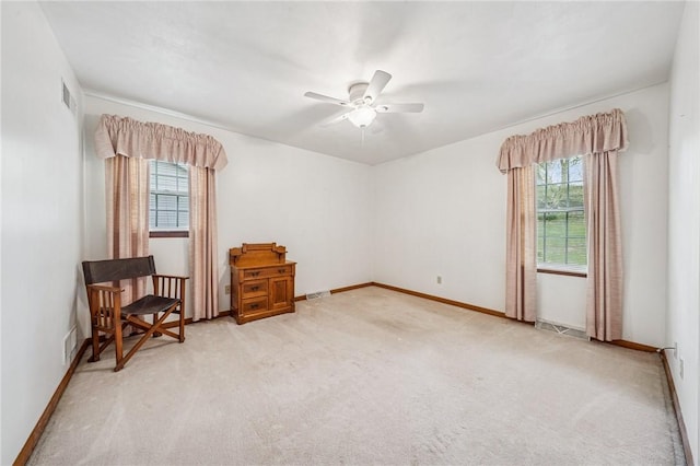 interior space featuring visible vents, a ceiling fan, carpet flooring, and plenty of natural light