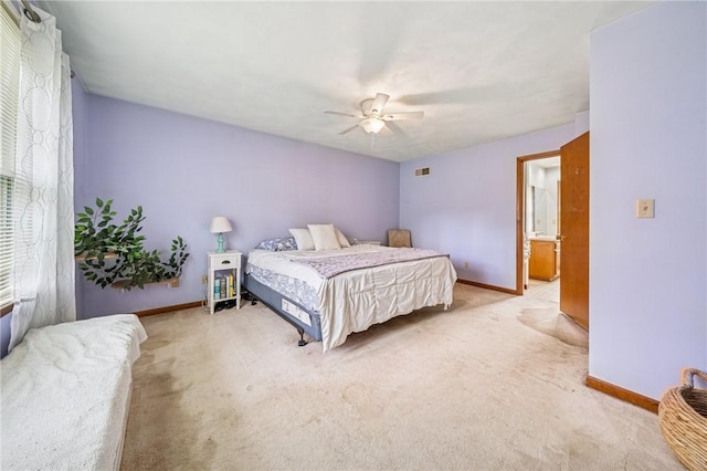 bedroom with light colored carpet and baseboards