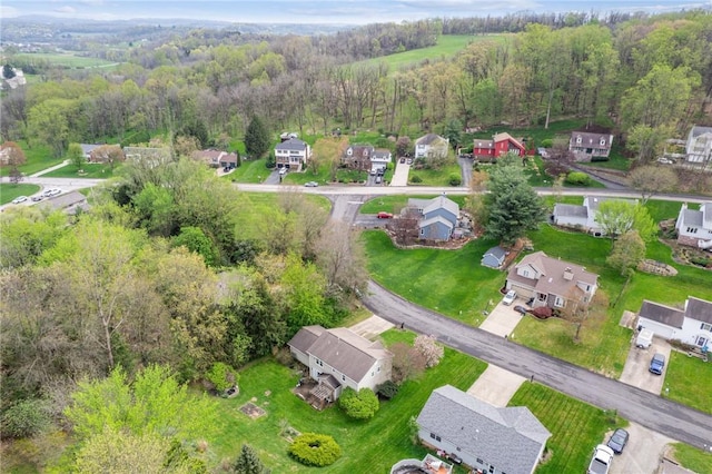 birds eye view of property with a forest view and a residential view