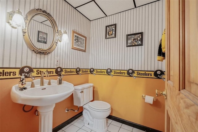 bathroom featuring toilet, wallpapered walls, and tile patterned floors