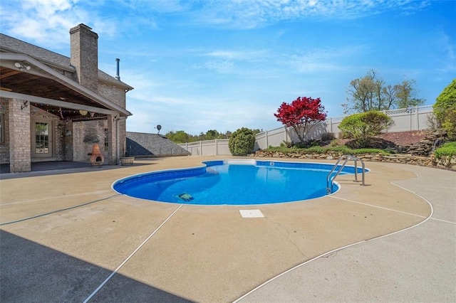 view of pool with a fenced in pool, a fenced backyard, and a patio area