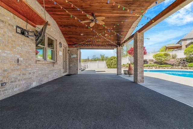 view of patio / terrace with ceiling fan and fence