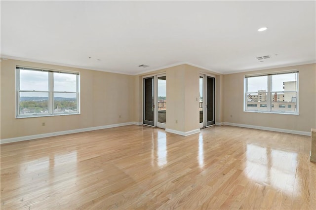 220 N Bellefield Ave Unit 903, Oakland, PA 15213 - unfurnished living room featuring light wood-type flooring, visible vents, and plenty of natural light