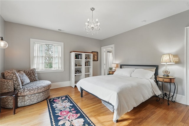 743 Chestnut Rd, Edgeworth, PA 15143 - bedroom featuring baseboards, visible vents, wood finished floors, and a notable chandelier