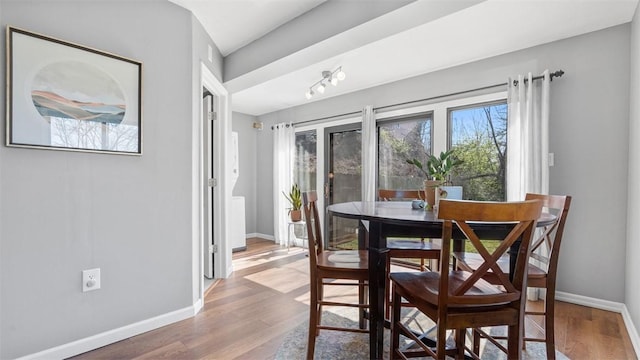 dining room featuring wood finished floors and baseboards