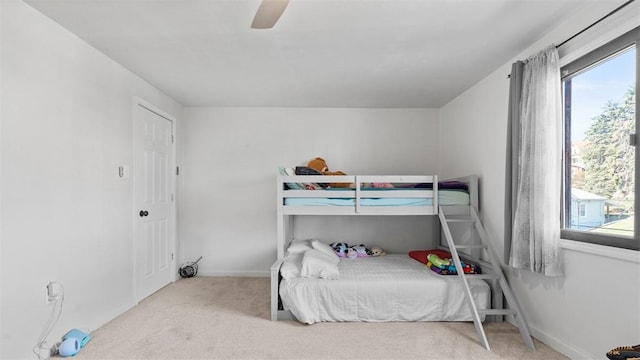 bedroom featuring a ceiling fan, carpet, and baseboards