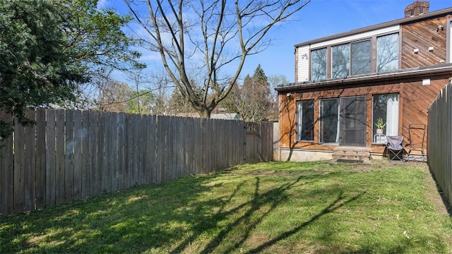 view of yard with entry steps and fence private yard