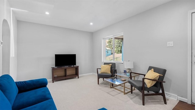 living room with baseboards, recessed lighting, and arched walkways