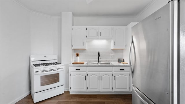 kitchen with tasteful backsplash, freestanding refrigerator, white range with gas cooktop, a sink, and white cabinetry