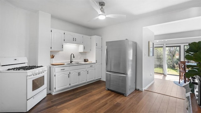 kitchen with freestanding refrigerator, dark wood-type flooring, white cabinetry, and white gas range