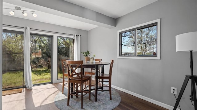 dining area with wood finished floors and baseboards