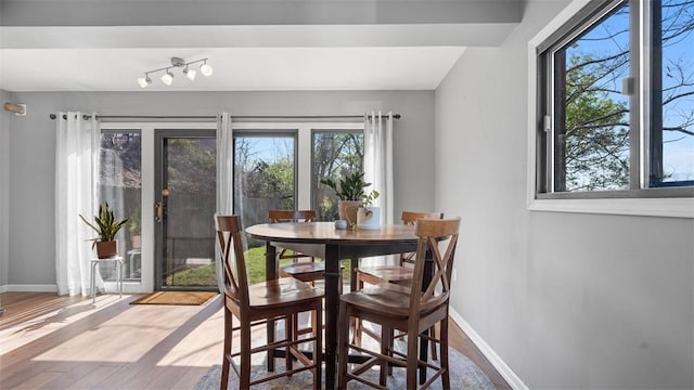 dining area featuring wood finished floors and baseboards