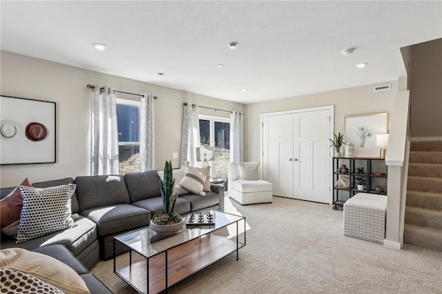 living room with recessed lighting, visible vents, stairway, and light colored carpet
