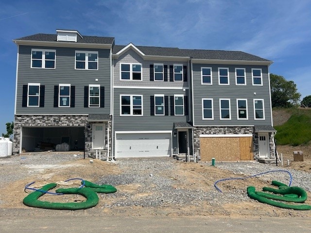 116 River Ridge Drive, Moon/Crescent Twp, PA 15108 - townhome / multi-family property with stone siding, an attached garage, and gravel driveway