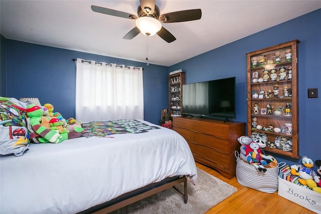 bedroom with wood finished floors and a ceiling fan