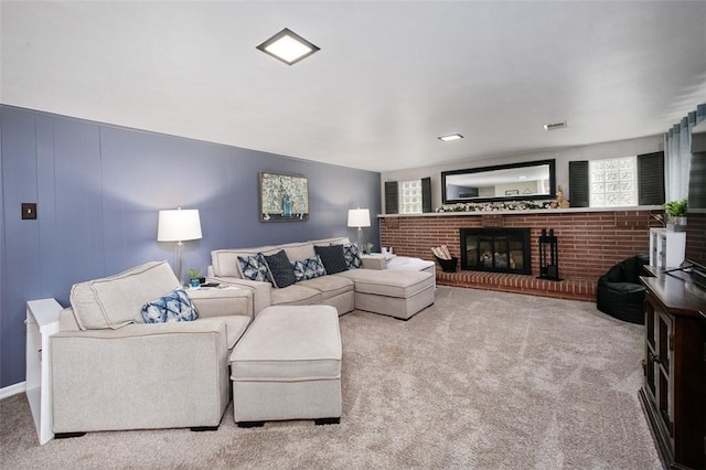 living room featuring a fireplace and carpet