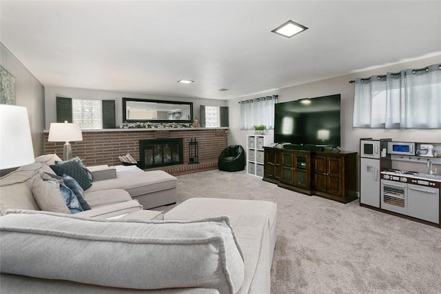 living room with a fireplace, carpet flooring, and a healthy amount of sunlight