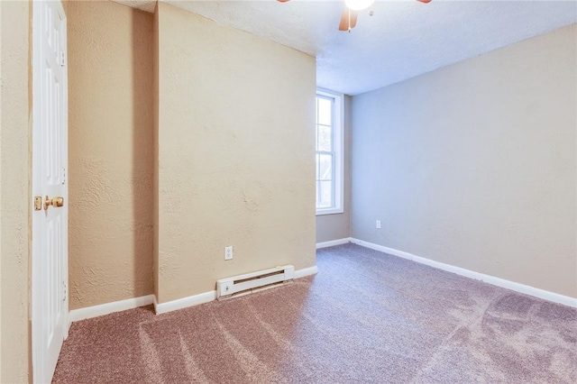 carpeted empty room featuring ceiling fan, a textured wall, a baseboard heating unit, and baseboards