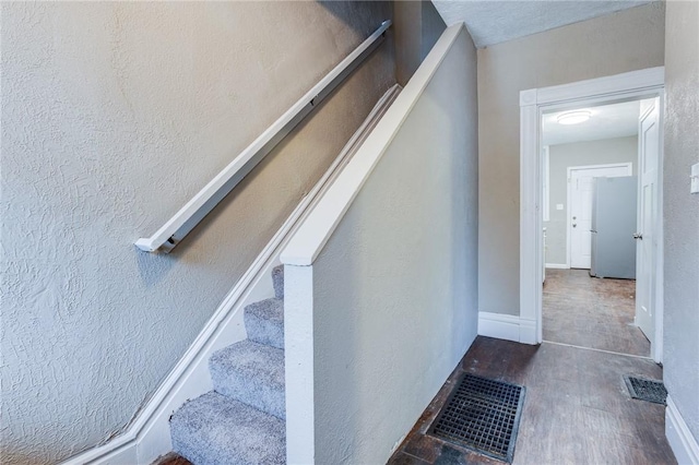 stairway featuring visible vents
