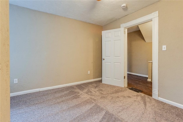 empty room with baseboards and carpet