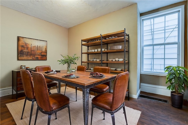 dining area featuring wood finished floors and baseboards