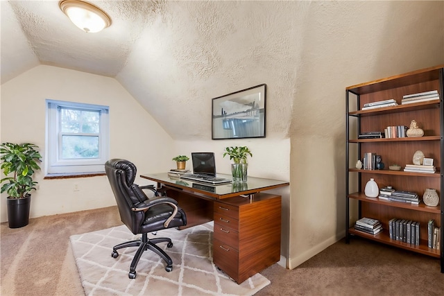 carpeted office space featuring a textured ceiling and vaulted ceiling