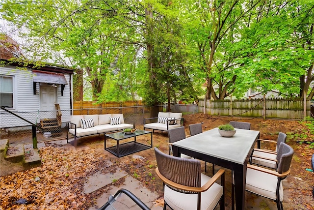 view of patio featuring an outdoor living space, a fenced backyard, and outdoor dining space