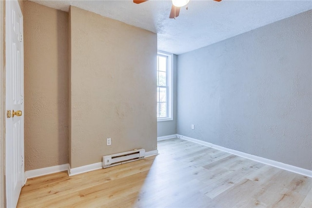 1226 Woodland Ave, Marshall Shadeland, PA 15212 - empty room featuring a baseboard heating unit, a ceiling fan, wood finished floors, a textured wall, and baseboards