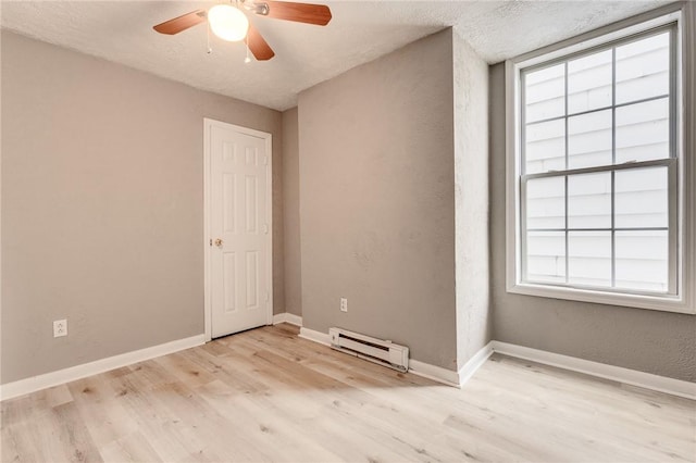 1226 Woodland Ave, Marshall Shadeland, PA 15212 - unfurnished room with baseboard heating, light wood-type flooring, ceiling fan, baseboards, and a textured wall