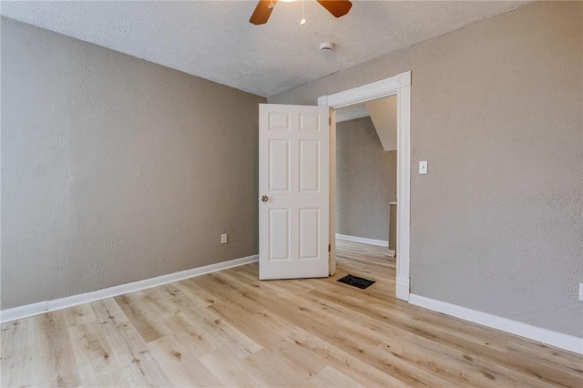 1226 Woodland Ave, Marshall Shadeland, PA 15212 - unfurnished room with wood finished floors, a ceiling fan, a textured wall, baseboards, and a textured ceiling