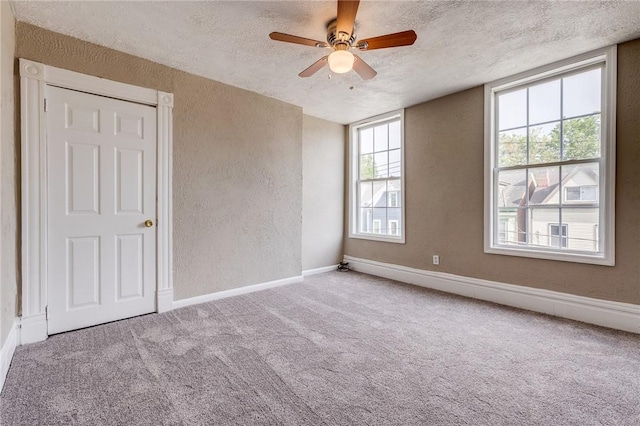1226 Woodland Ave, Marshall Shadeland, PA 15212 - carpeted spare room featuring a textured wall, a textured ceiling, ceiling fan, plenty of natural light, and baseboards