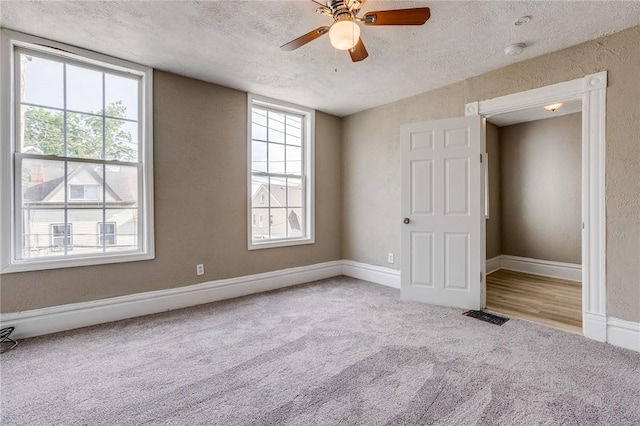 1226 Woodland Ave, Marshall Shadeland, PA 15212 - unfurnished bedroom with carpet flooring, a textured ceiling, multiple windows, baseboards, and ceiling fan