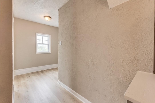 1226 Woodland Ave, Marshall Shadeland, PA 15212 - hallway with light wood-style floors, baseboards, a textured ceiling, and a textured wall