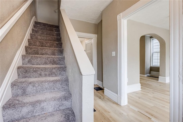 1226 Woodland Ave, Marshall Shadeland, PA 15212 - stairs with arched walkways, wood finished floors, and baseboards