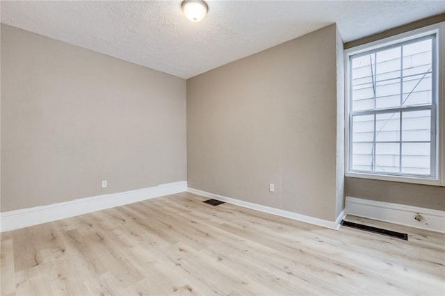 1226 Woodland Ave, Marshall Shadeland, PA 15212 - spare room with wood finished floors, a textured ceiling, and baseboards