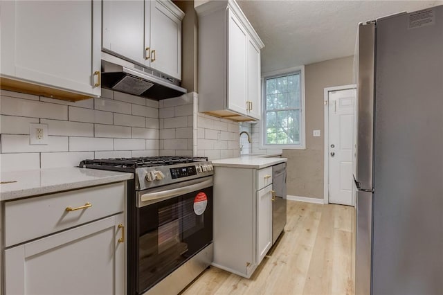 1226 Woodland Ave, Marshall Shadeland, PA 15212 - kitchen featuring appliances with stainless steel finishes, under cabinet range hood, light wood-type flooring, baseboards, and backsplash