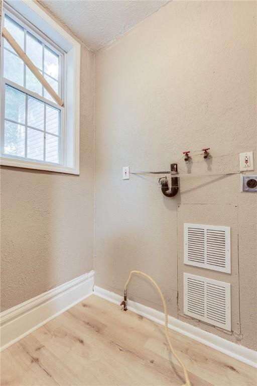1226 Woodland Ave, Marshall Shadeland, PA 15212 - laundry room with baseboards, wood finished floors, hookup for a washing machine, and a textured ceiling