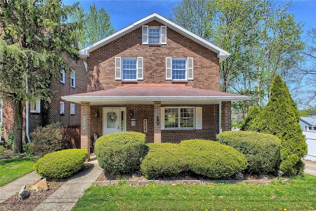 view of front facade with a porch and brick siding