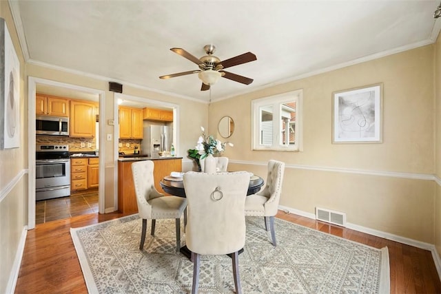 dining area with dark wood-style flooring, visible vents, a ceiling fan, and baseboards
