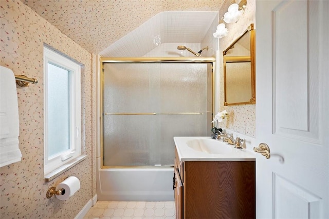 full bath with enclosed tub / shower combo, wallpapered walls, vaulted ceiling, and vanity
